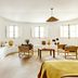 Le Moulin, Lourmarin, a Beaumier Hotel lounge with curved seating, wicker chairs and bright windows