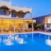 Esmeralda Hotel in Kremastí with outdoor pool and poolside dining terrace at dusk
