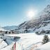 Hotel Zurserhof in Zürs with snowy alpine slopes and a bright winter mountain view