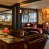 The White Horse, Dorking: cozy hotel lounge with leather chairs, bar counter, and warm lighting