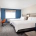 Holiday Inn Express Portland South - Lake Oswego guest room with two beds, blue accent wall and seating area