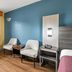 Econo Lodge Charlotte Airport Area room in Charlotte with two chairs, table, window and wall-mounted AC
