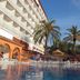 Ibersol Playa Dorada in El Vendrell with a palm-lined outdoor pool and sea-view hotel terrace