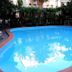 Hotel Splendid Mare in Laigueglia with a bright outdoor pool surrounded by lounge chairs and greenery