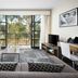 Quest Narre Warren hotel room with balcony view, sofa, desk, and TV in Narre Warren