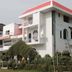 Hotel Buddha International in Bodh Gaya, white hotel exterior with red roof and arched balconies
