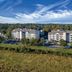 Club Wyndham Nashville hotel buildings with parking lot and wooded hillside backdrop in Nashville