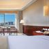 Lihua Grand Hotel in Taiyuan guest room with city view, desk, seating area, and large window