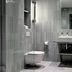 Boutique Hotel Hans Copenhagen bathroom with wall-mounted toilet, sink vanity and gray tile shower area