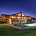 Vitina House in Vytina with illuminated outdoor pool and lounge chairs at dusk