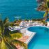 Golden Tulip Dar Es Salaam pool terrace with ocean views and palm trees in Dar Es Salaam