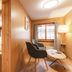 Gasthof Bären Habkern room with seating area, bed, wood-paneled walls and window view