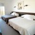 Hotel De La Plage in Valras-Plage: bright twin room with balcony doors and desk