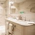 Abbaye De Villeneuve bathroom in Les Sorinières with marble shower, double vanity and large mirror