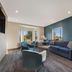 SureStay Plus by Best Western Highland Poughkeepsie lounge with blue sofa, chairs and bay window
