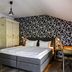 Hotel Ulmenhof & Spa in Bredstedt: double bed room with patterned accent wall and desk