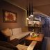 City Residence Apartment Hotel in Košice: cozy lounge with sofa, coffee table, bar seating, and fireplace