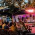 Outdoor evening dining at Reimersholme Hotel in Stockholm with guests seated under umbrellas