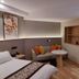 Yangjianhua Hotel in Shanghai guest room with bed, sofa, round table and wall shelf