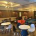 Hiroshima Ekimae Green Hotel lobby lounge in Hiroshima with seating area and round tables