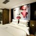 Dunhe Apartment Guangzhou hotel room with king bed and large face artwork headboard