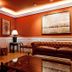 Hotel Fraga do Eume in Capela: elegant lounge with fireplace, leather sofa, lamp, and red walls