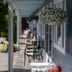 Governor's Rock Motel in Shaftsbury with a shaded porch, hanging flower baskets, and outdoor seating