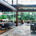 Crystalbrook Byron in Byron Bay outdoor lounge with seating and lush garden views
