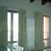 Hotel La Rosta in Reggio nell'Emilia room with balcony doors, curtains and radiator