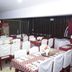 Hotel Apple Valley in Kodaikanal dining room with tables set for guests and white-covered chairs