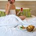 Hôtel Restaurant Au Boeuf in Blaesheim guest in bed with towel turban, phone and drink, breakfast tray
