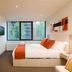 City Tempo Melbourne hotel room with king bed, orange accents and large window view