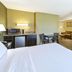 Country Inn & Suites by Radisson, Benton Harbor-St room with king bed, TV, desk, and sitting area