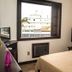 Maratea Mare room in Florianopolis with bed, window view, and beach-themed wall art