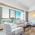 Lihua Grand Hotel in Taiyuan with bright sitting area, large city view window, sofa and armchairs
