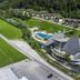 Eco Terme Snovik in Laze v Tuhinju, aerial view of resort buildings, outdoor pools and green hills