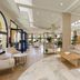 Sol Sancti Petri in Chiclana de la Frontera lobby with beige seating, coffee table, and skylit atrium