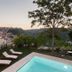 Giardino Sul Duomo in Ragusa with a small pool, lounge chairs and hillside city views at sunset