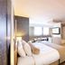 Vibe Hotel Singapore Orchard guest room with king bed, seating area and wall-mounted TV in Singapore