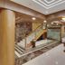 Hotel Centra-Ahmedabad lobby in Ahmedabad with marble floors, staircase, and seating area