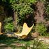 Le Moulin, Lourmarin by Beaumier Hotel: two yellow lounge chairs in a lush garden seating area