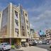 Hotel G Shy in Bhopal, exterior view of a corner hotel building on a busy street