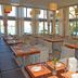 Karystion Hotel in Kárystos restaurant with set tables and sea views through large windows