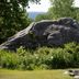 Governor's Rock Motel in Shaftsbury with large rock outcrop, greenery, and roadside sign