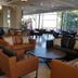 Royal Plaza Hotel in Tiberias lobby with leather seating, round tables and large windows