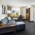 Residence Inn by Marriott Las Vegas Stadium Area suite with sofa, desk, dining table and mountain view