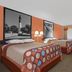 Super 8 by Wyndham Port Royal/Beaufort guest room with two beds, desk, and window with curtains