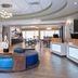 Holiday Inn Express & Suites Lakeland South lobby with seating area, front desk and dining space