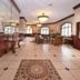 Shilo Inn Suites Hotel - Killeen lobby with tile floor, seating area, and large arched windows