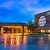 Four Points by Sheraton Milwaukee North Shore in Brown Deer, exterior at dusk with wet pavement reflections